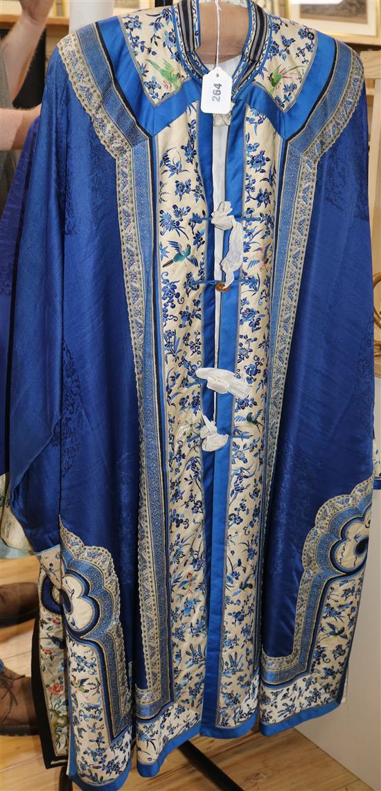 A Chinese silk embroidered robe c.1920s, embroidered with panels of birds and flowers on royal blue silk